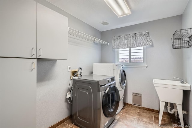 5784 W 81st Cir, Arvada, CO 80003 - washroom featuring separate washer and dryer, cabinet space, and baseboards
