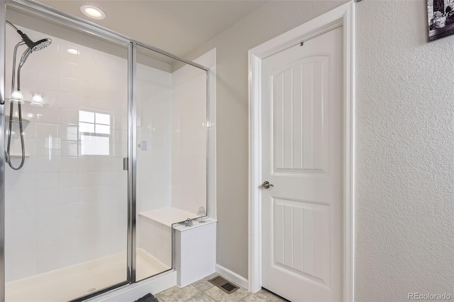 bathroom with a shower with shower door