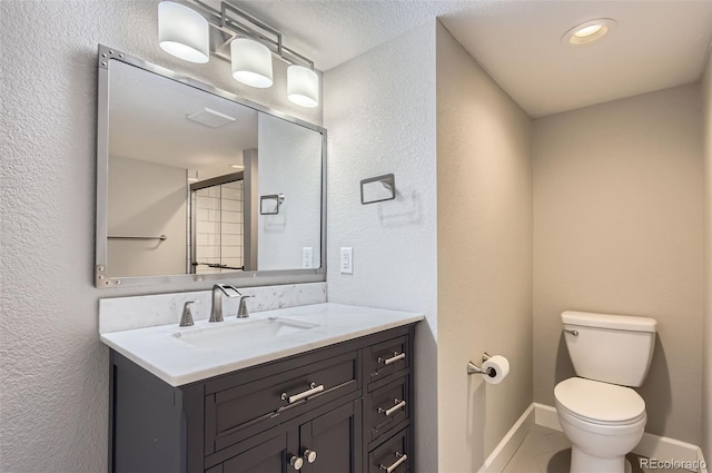 bathroom with tile patterned flooring, vanity, and toilet