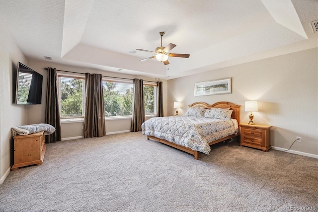 16498 E Lake Dr, Centennial, CO 80016 - carpeted bedroom featuring a raised ceiling and a ceiling fan
