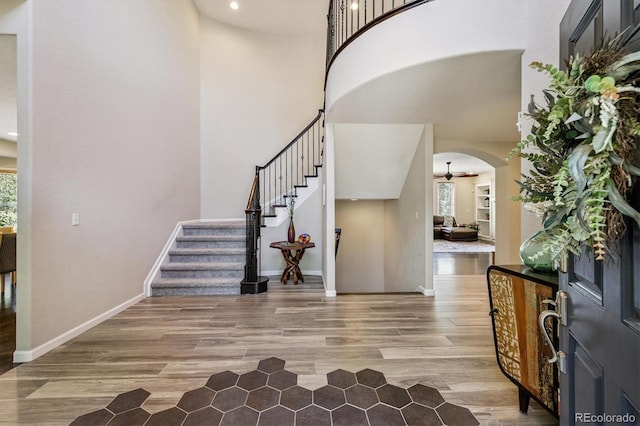 16498 E Lake Dr, Centennial, CO 80016 - foyer entrance featuring arched walkways, stairway, plenty of natural light, light wood-style flooring, and recessed lighting