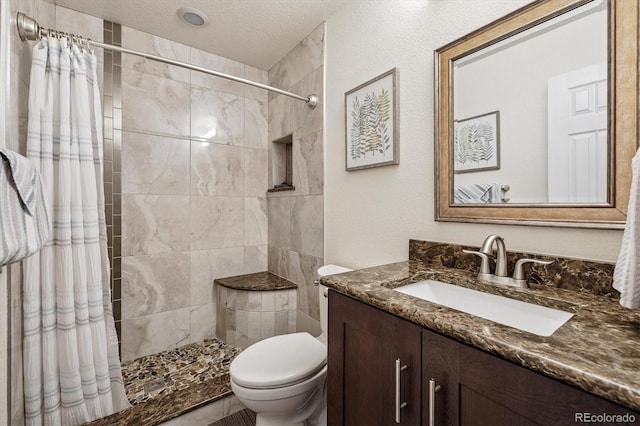 16498 E Lake Dr, Centennial, CO 80016 - bathroom featuring vanity, tiled shower, and a textured ceiling