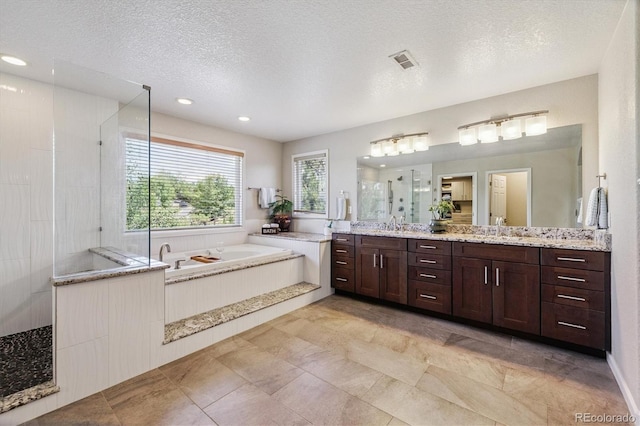 16498 E Lake Dr, Centennial, CO 80016 - full bathroom with a shower stall, double vanity, a garden tub, a textured ceiling, and recessed lighting