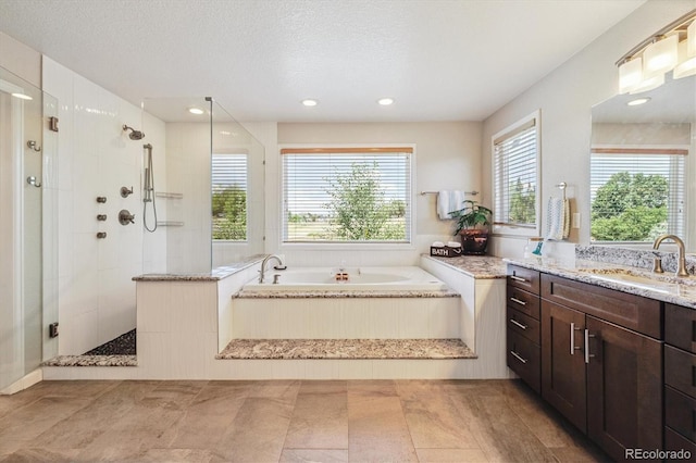 16498 E Lake Dr, Centennial, CO 80016 - full bathroom featuring tiled shower, vanity, a garden tub, a textured ceiling, and recessed lighting