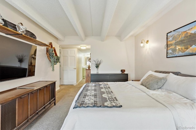 bedroom featuring beamed ceiling, light carpet, and a textured ceiling