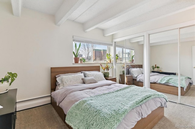 bedroom featuring two closets, beam ceiling, baseboard heating, carpet flooring, and a textured ceiling