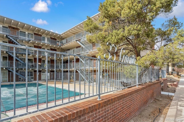 view of swimming pool with a swimming pool and fence