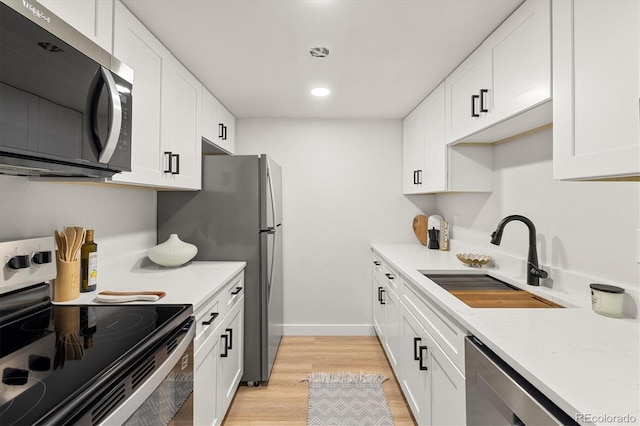 7770 W 38th Ave Unit 108, Wheat Ridge, CO 80033 - kitchen with white cabinets, appliances with stainless steel finishes, and a sink