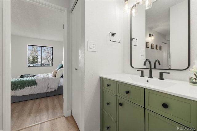 7770 W 38th Ave Unit 108, Wheat Ridge, CO 80033 - bathroom with ensuite bath, vanity, and wood finished floors