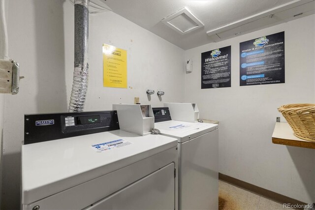 7770 W 38th Ave Unit 108, Wheat Ridge, CO 80033 - common laundry area featuring baseboards, washing machine and clothes dryer, and attic access