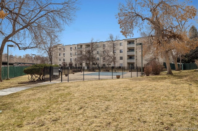 7770 W 38th Ave Unit 108, Wheat Ridge, CO 80033 - view of community featuring fence and a lawn