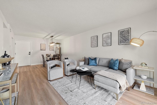 7770 W 38th Ave Unit 108, Wheat Ridge, CO 80033 - living area featuring a textured ceiling, baseboards, and wood finished floors