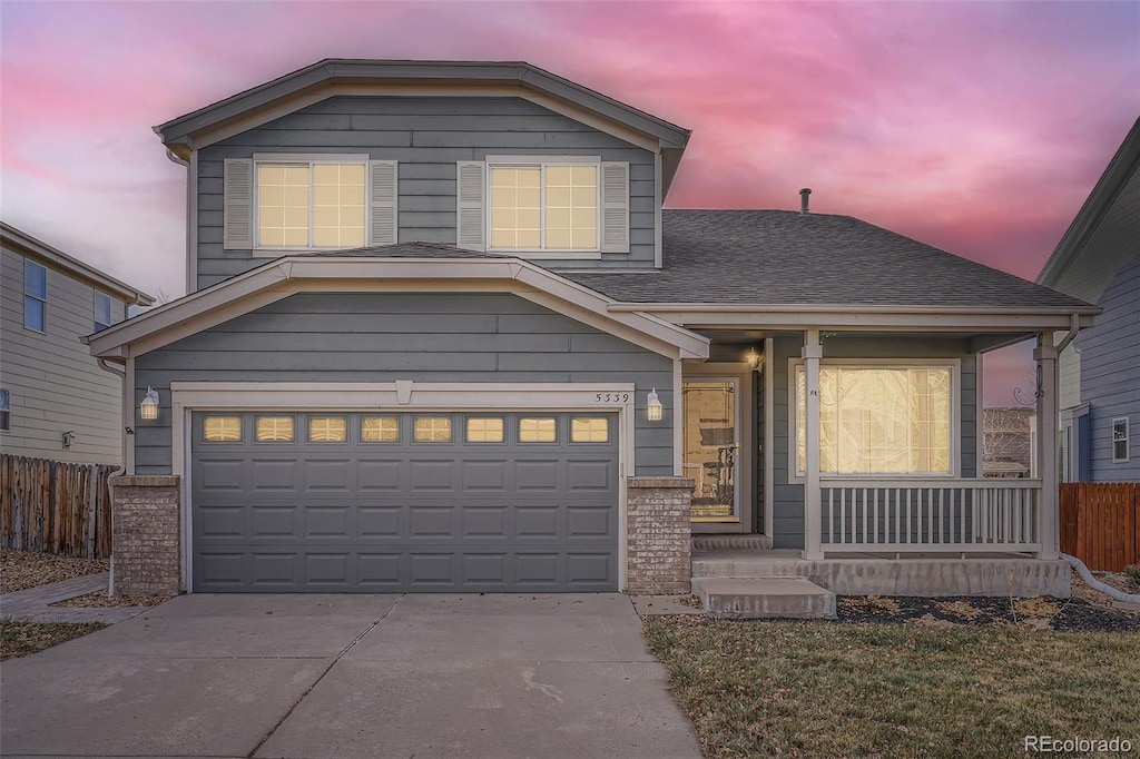 view of front of home with covered porch and a garage