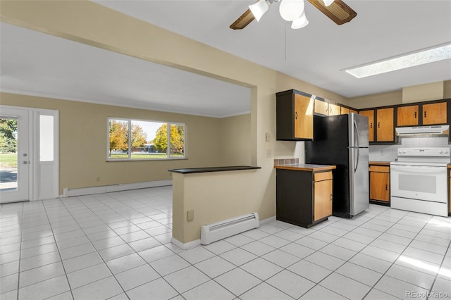 kitchen featuring a wealth of natural light, a baseboard radiator, white electric range oven, and stainless steel fridge