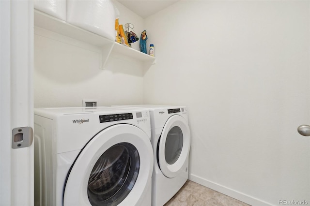 laundry room with light tile patterned flooring and separate washer and dryer