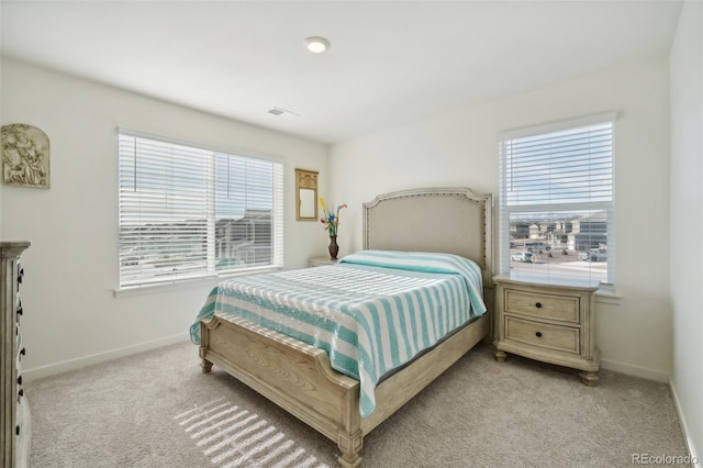 carpeted bedroom with multiple windows