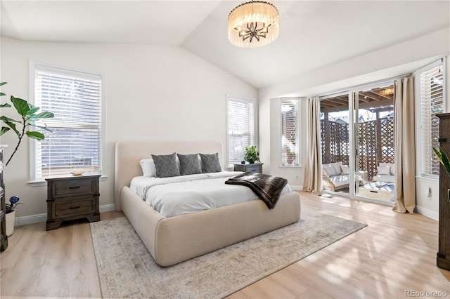 bedroom featuring multiple windows, vaulted ceiling, access to exterior, and light hardwood / wood-style flooring