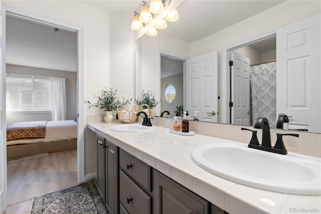 bathroom featuring vanity, wood-type flooring, and a chandelier