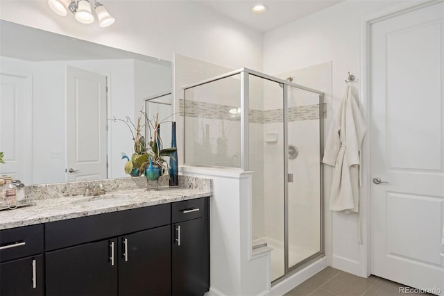 bathroom with tile patterned floors, vanity, and a shower with shower door