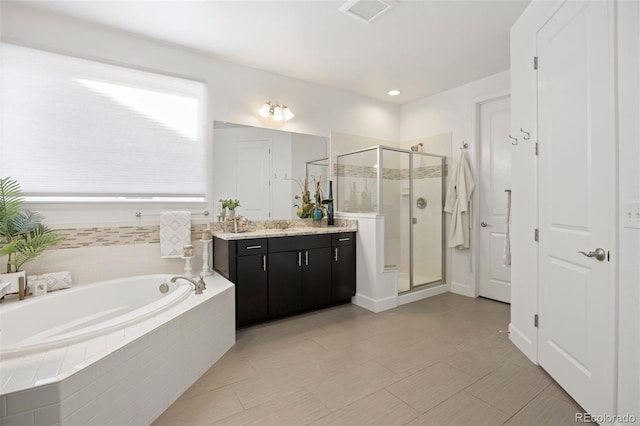 bathroom featuring vanity and plus walk in shower