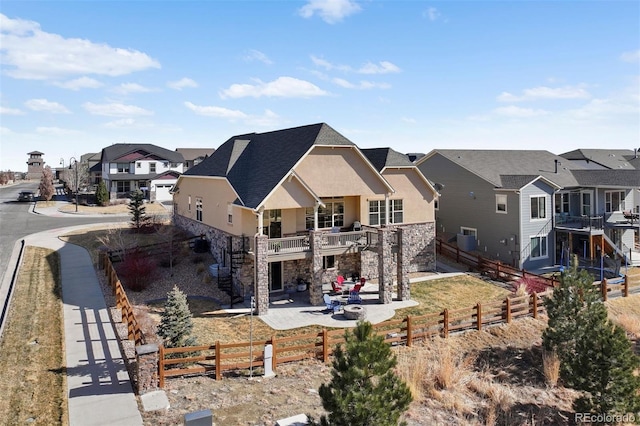 back of house featuring a patio and a balcony