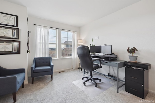 carpeted office space featuring visible vents and baseboards