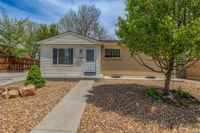 7828 Florado St, Denver, CO 80221 - view of front facade featuring fence and brick siding