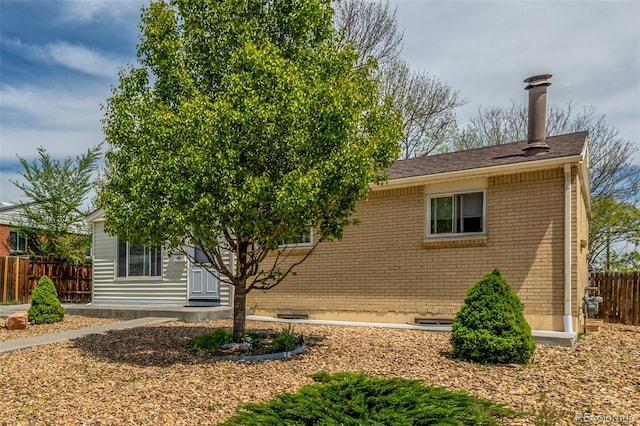 7828 Florado St, Denver, CO 80221 - ranch-style house with fence, brick siding, and a chimney