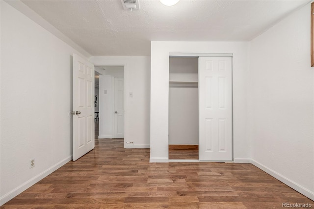 7828 Florado St, Denver, CO 80221 - unfurnished bedroom with wood finished floors, baseboards, and a closet