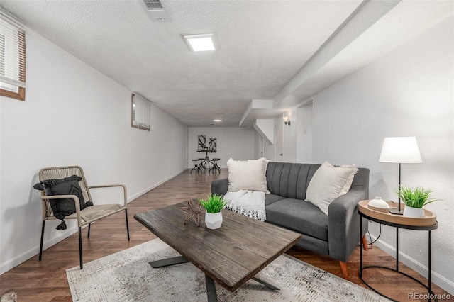 7828 Florado St, Denver, CO 80221 - living area featuring baseboards, wood finished floors, and a textured ceiling