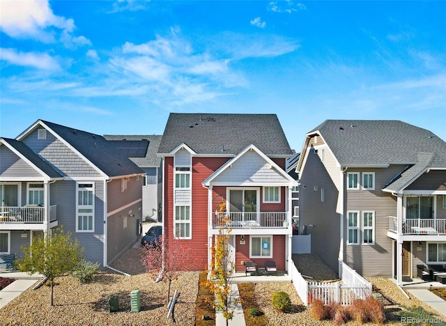 view of front of property with a patio and a balcony