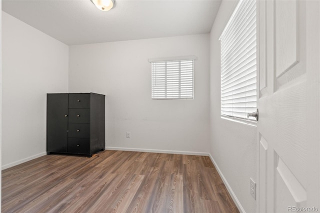 unfurnished bedroom with hardwood / wood-style floors