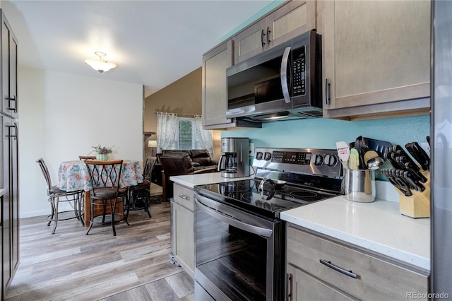 7840 S Windermere Cir, Littleton, CO 80120 - kitchen featuring stainless steel appliances, light wood-style flooring, and light stone counters
