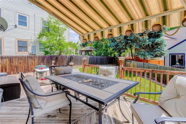 7840 S Windermere Cir, Littleton, CO 80120 - wooden deck with outdoor dining space and a fenced backyard