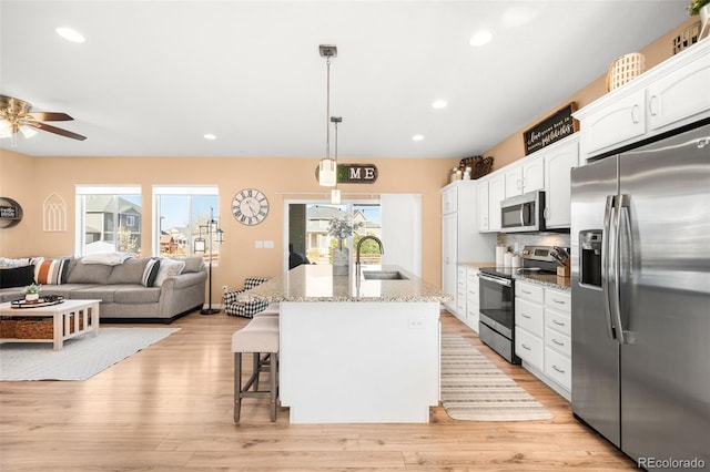 11052 Sedalia St, Commerce City, CO 80022 - kitchen with a sink, white cabinets, appliances with stainless steel finishes, and plenty of natural light