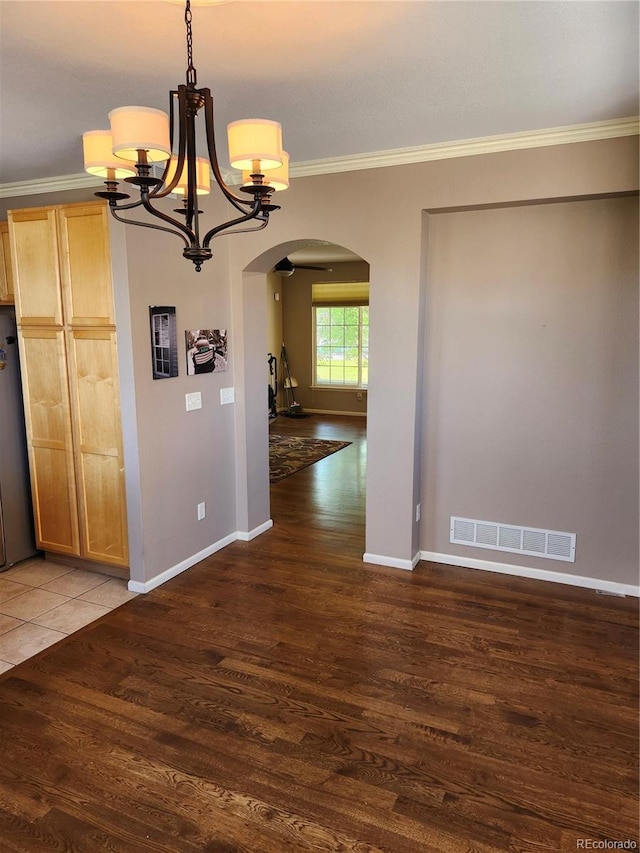 unfurnished dining area featuring dark wood-type flooring and ornamental molding