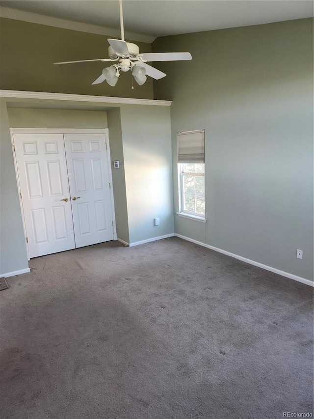 unfurnished bedroom featuring a closet, ceiling fan, and carpet