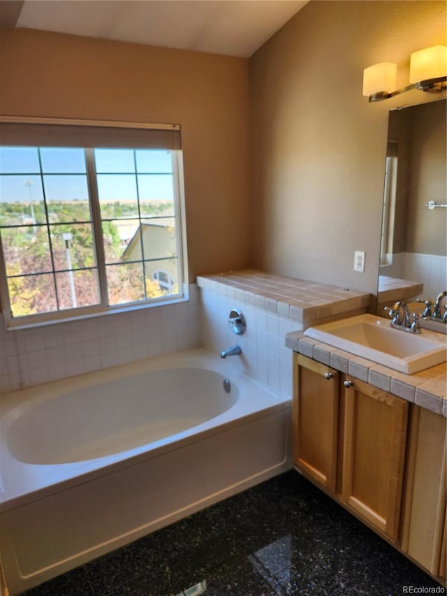 bathroom featuring vanity and a bathtub