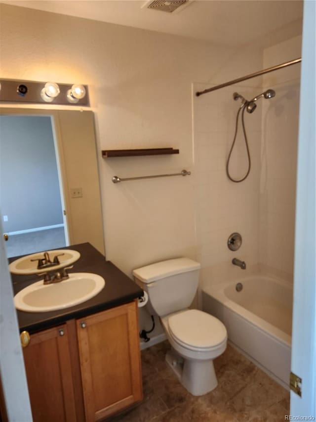 full bathroom featuring vanity, tiled shower / bath combo, toilet, and tile patterned floors