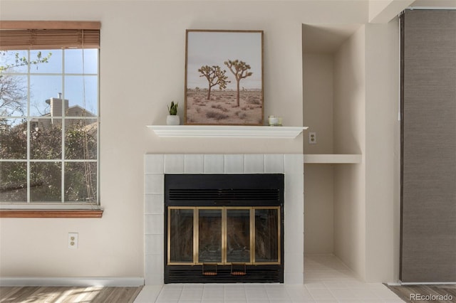 detailed view of a tiled fireplace and wood finished floors