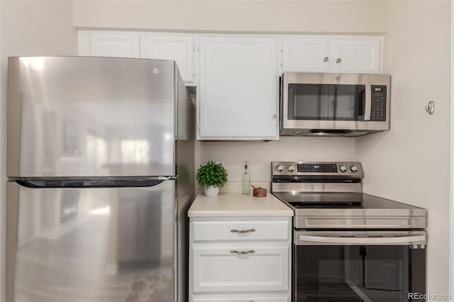 kitchen with appliances with stainless steel finishes, white cabinets, and light countertops