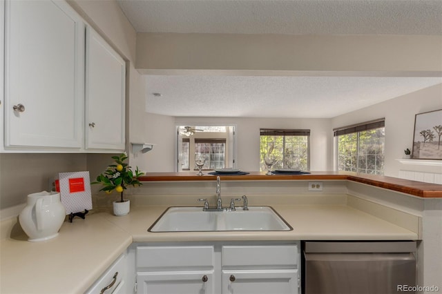 kitchen with dishwasher, a sink, white cabinetry, a textured ceiling, and light countertops