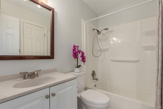 full bath featuring a textured wall, vanity, toilet, and shower / tub combination