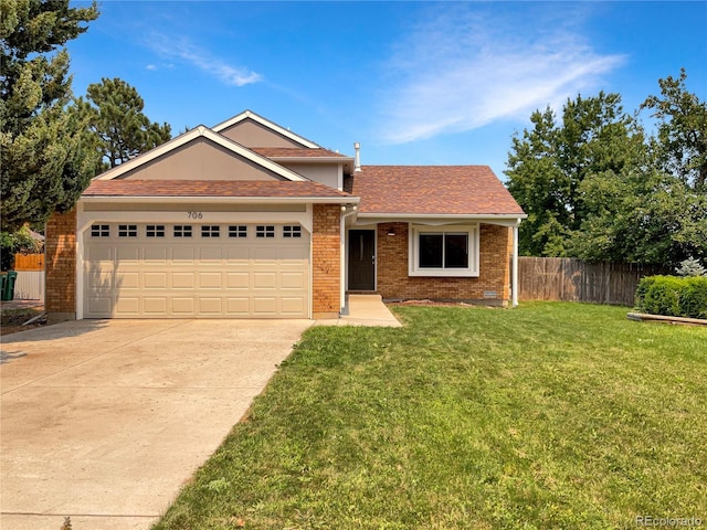 view of front of home featuring a garage and a front lawn