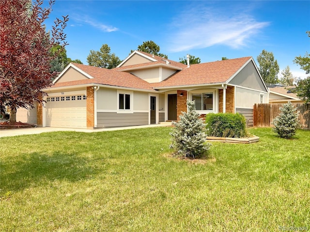 view of front of property featuring a garage and a front yard