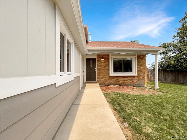 entrance to property with a yard