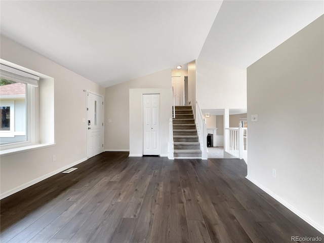 unfurnished living room with lofted ceiling and dark hardwood / wood-style floors