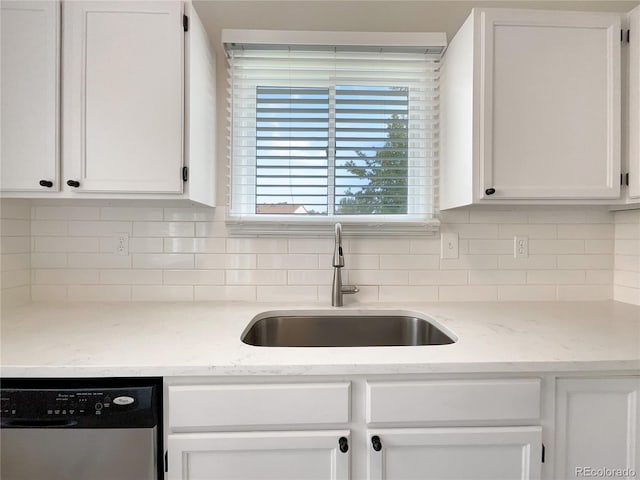 kitchen with dishwasher, light stone countertops, sink, and white cabinets