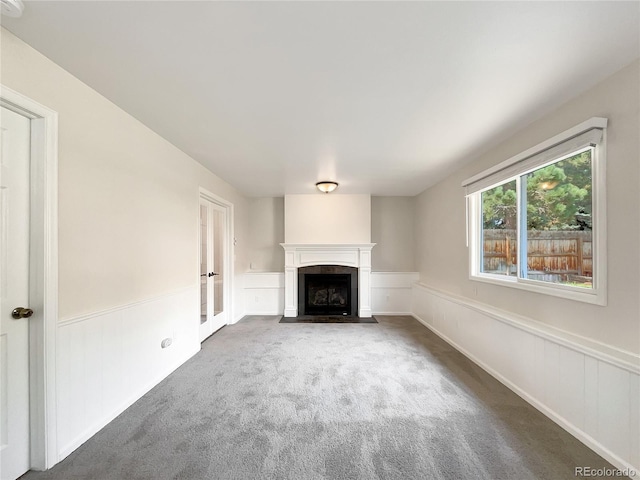 unfurnished living room featuring dark carpet