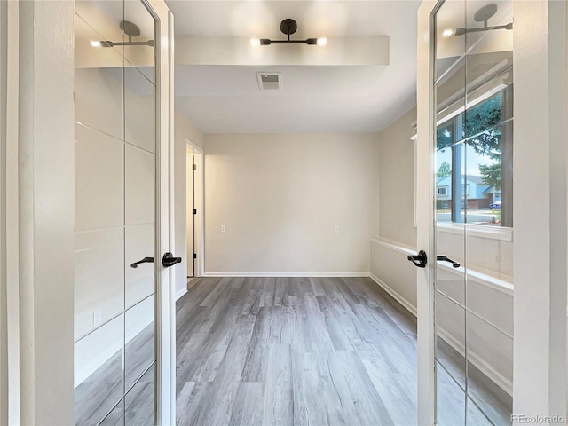 empty room featuring hardwood / wood-style floors and french doors